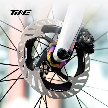 TiNE Tapa Center Lock Exterior de Titanio en acabado Chroma Dream (tornasolado) montada en la rueda delantera
